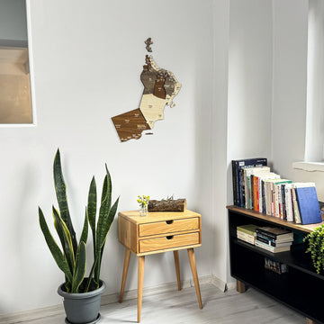 Oman wooden wall map hung high on a white wall in a reading corner, wide shot