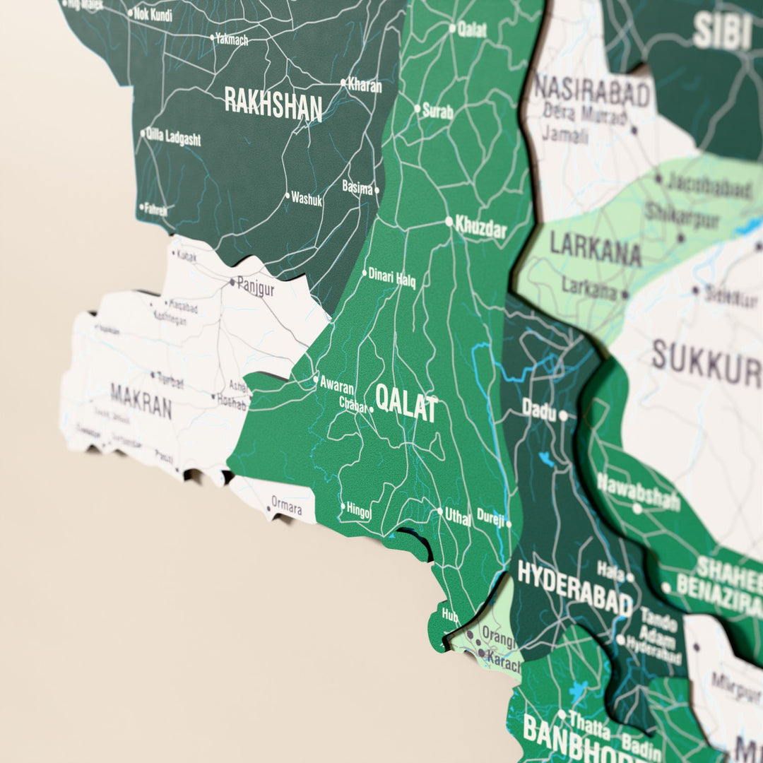 Close-up of the Flag colored Pakistan wooden wall map with layered regions and printed names