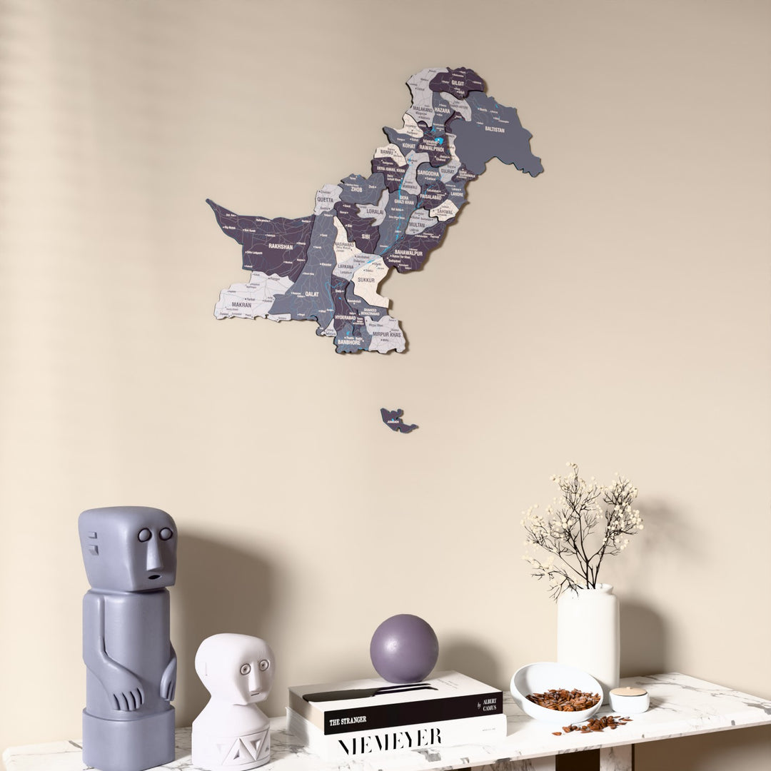 Nimbus Pakistan wooden wall map on a beige wall above a console with figurines