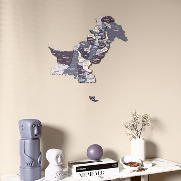 Nimbus Pakistan wooden wall map on a beige wall above a console with figurines