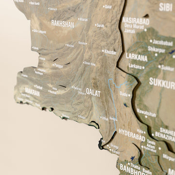Close-up of the Satellite Pakistan wooden wall map with layered regions and printed names