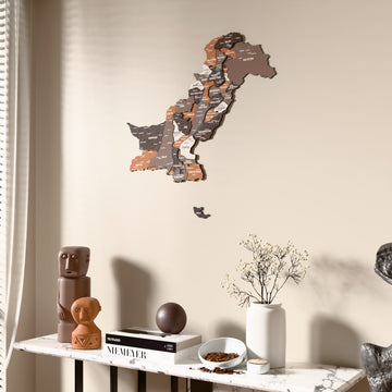 Soil Pakistan wooden wall map beside a sheer curtain, angled view