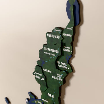 Close-up of the Satellite Palau wooden wall map with layered regions and printed names