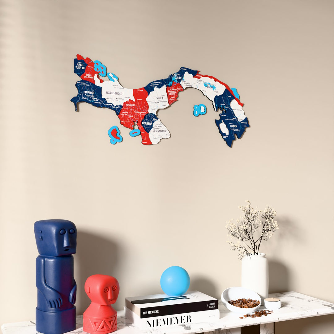 Flag colored Panama wooden wall map on a beige wall above a console with figurines