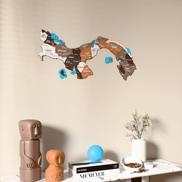 Soil Panama wooden wall map on a beige wall above a console with figurines