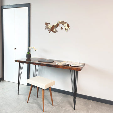 Wooden Panama map above a hairpin-leg desk and stool, view with a door at left