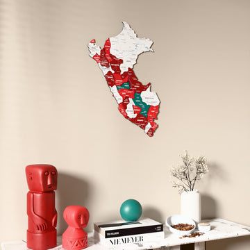 Flag colored Peru wooden wall map on a beige wall above a console with figurines