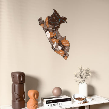 Soil Peru wooden wall map on a beige wall above a console with figurines