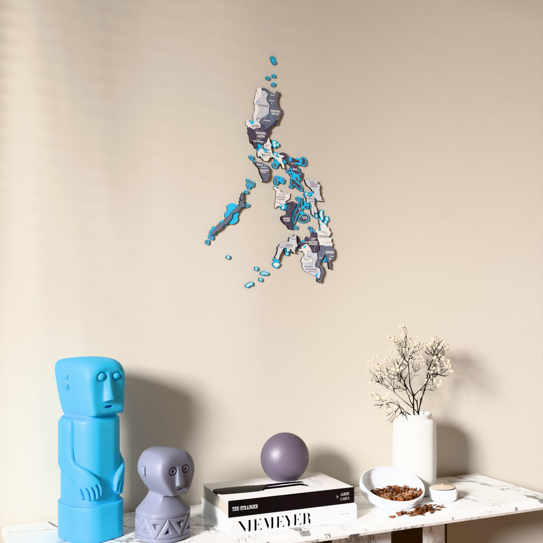 Nimbus Philippines wooden wall map on a beige wall above a console with figurines