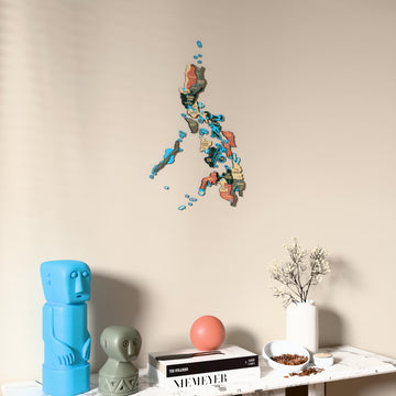 Sage Philippines wooden wall map on a beige wall above a console with figurines