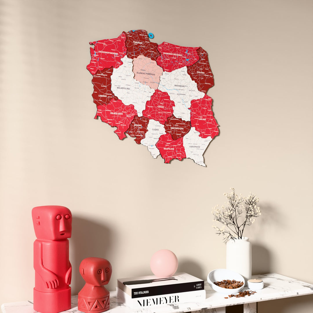 Flag colored Poland wooden wall map on a beige wall above a console with figurines