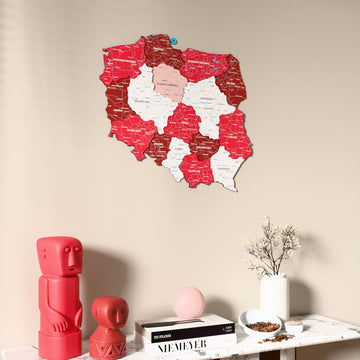 Flag colored Poland wooden wall map on a beige wall above a console with figurines