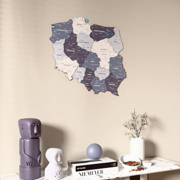 Nimbus Poland wooden wall map on a beige wall above a console with figurines