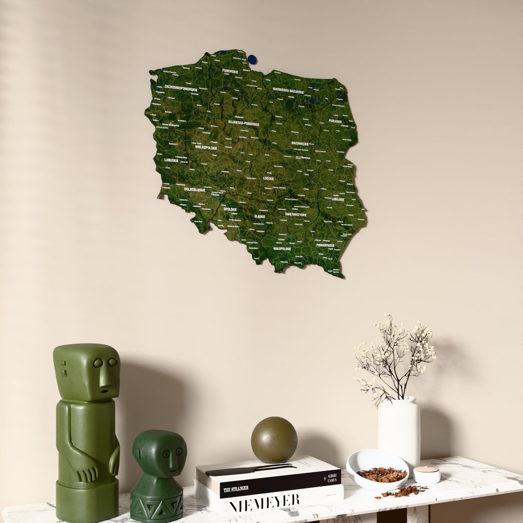 Satellite Poland wooden wall map on a beige wall above a console with figurines