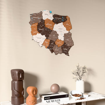 Soil Poland wooden wall map on a beige wall above a console with figurines