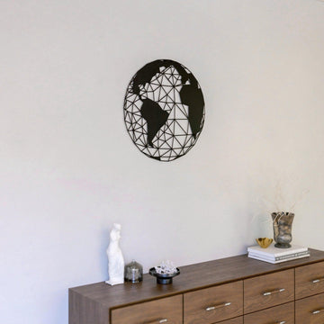 Black polygon world map metal wall art above a wooden dresser