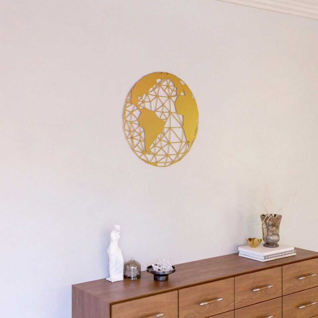 Gold polygon world map metal wall art above a dresser