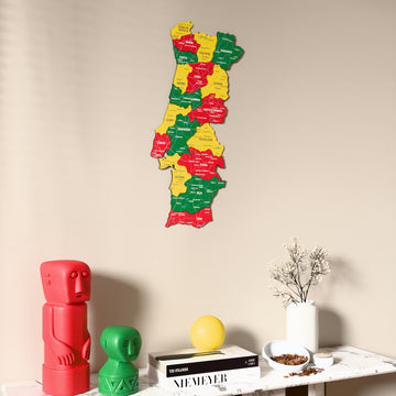 Flag colored Portugal wooden wall map on a beige wall above a console with figurines