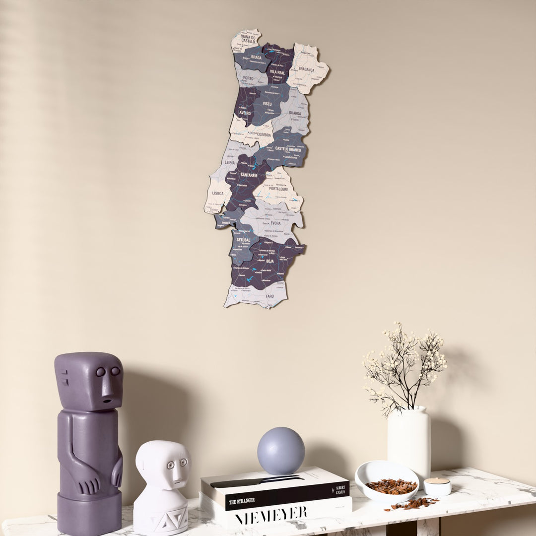 Nimbus Portugal wooden wall map on a beige wall above a console with figurines