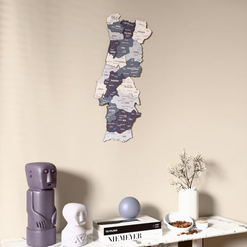 Nimbus Portugal wooden wall map on a beige wall above a console with figurines