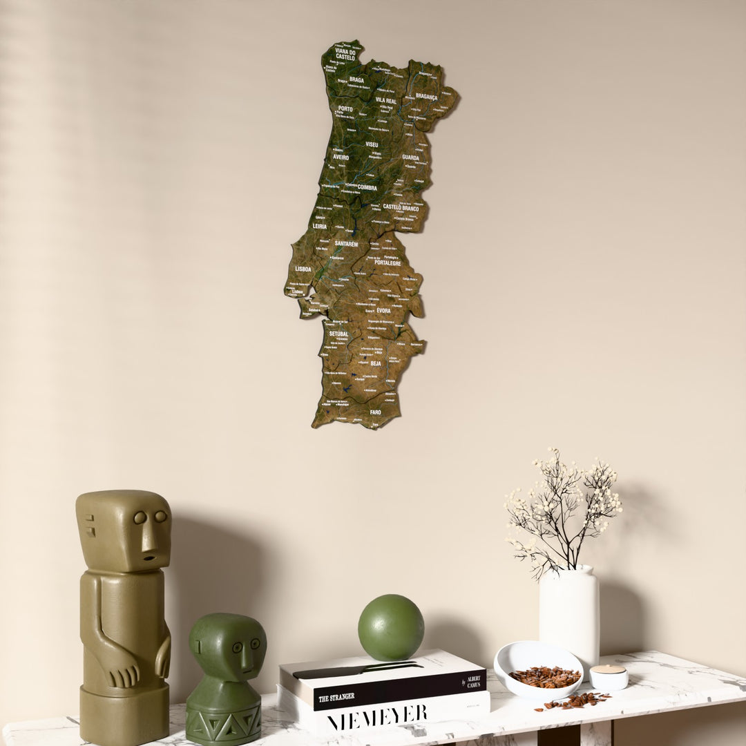 Satellite Portugal wooden wall map on a beige wall above a console with figurines