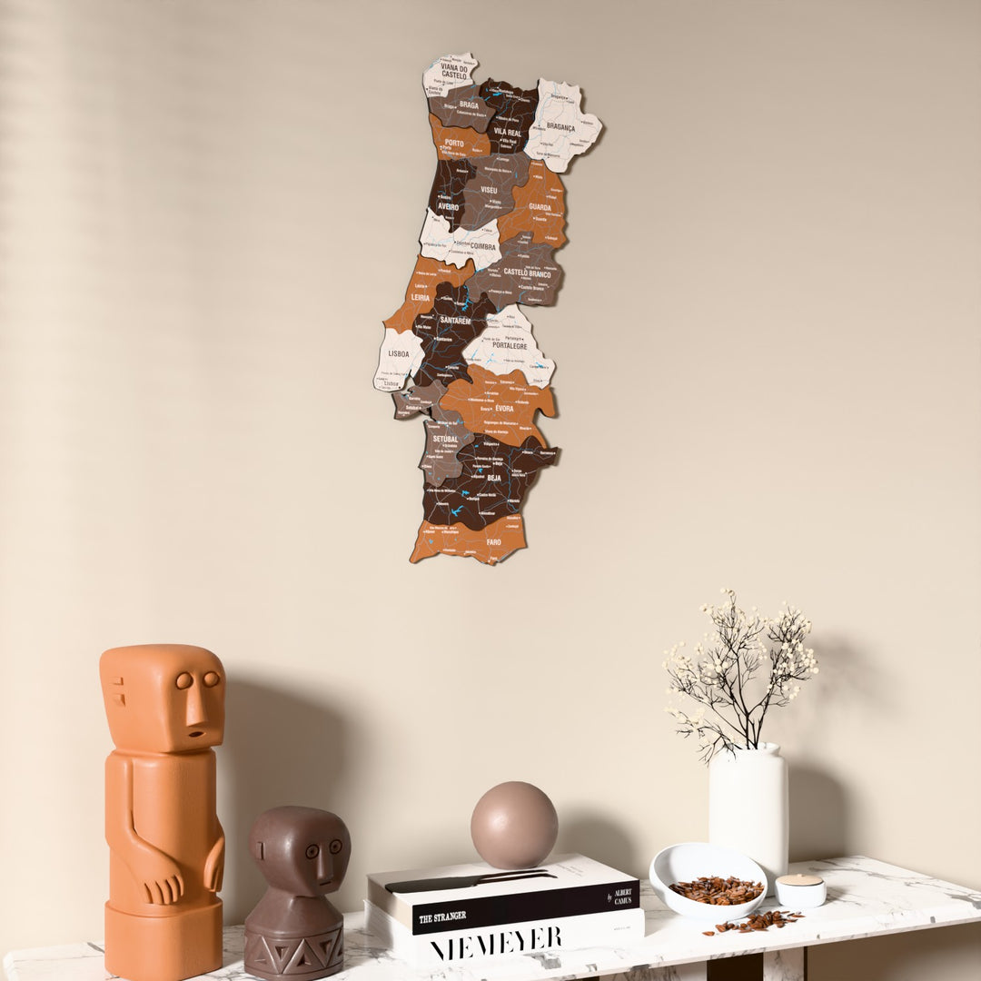 Soil Portugal wooden wall map on a beige wall above a console with figurines