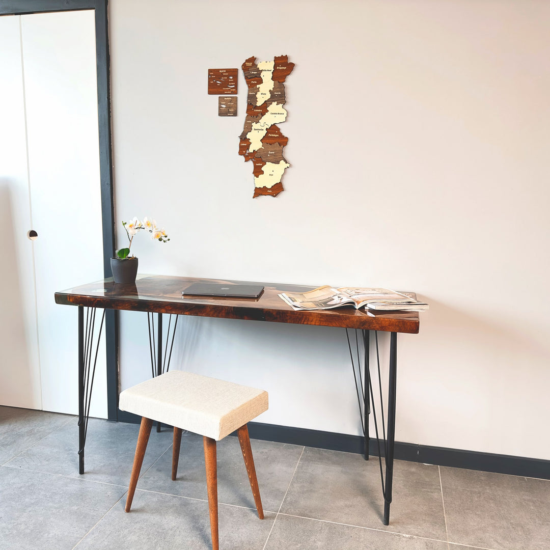 Portugal wooden wall map above a desk with a cream stool in front of a white door
