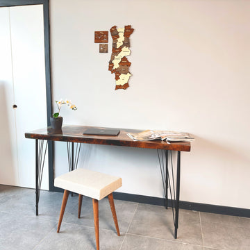 Portugal wooden wall map above a desk with a cream stool in front of a white door
