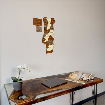 Portugal wooden wall map seen from the left above the corner of a resin desk with an orchid