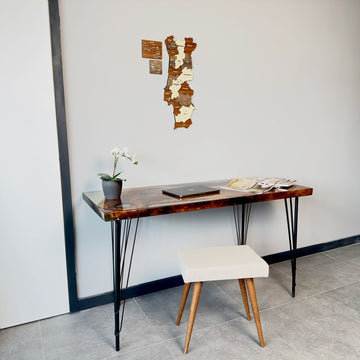 Portugal wooden wall map above a desk with a cream stool, medium view