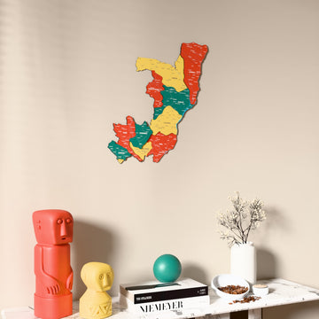 Flag colored Republic of the Congo wooden wall map on a beige wall above a console with figurines