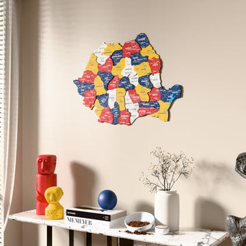 Flag colored Romania wooden wall map beside a sheer curtain, angled view