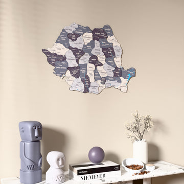 Nimbus Romania wooden wall map on a beige wall above a console with figurines