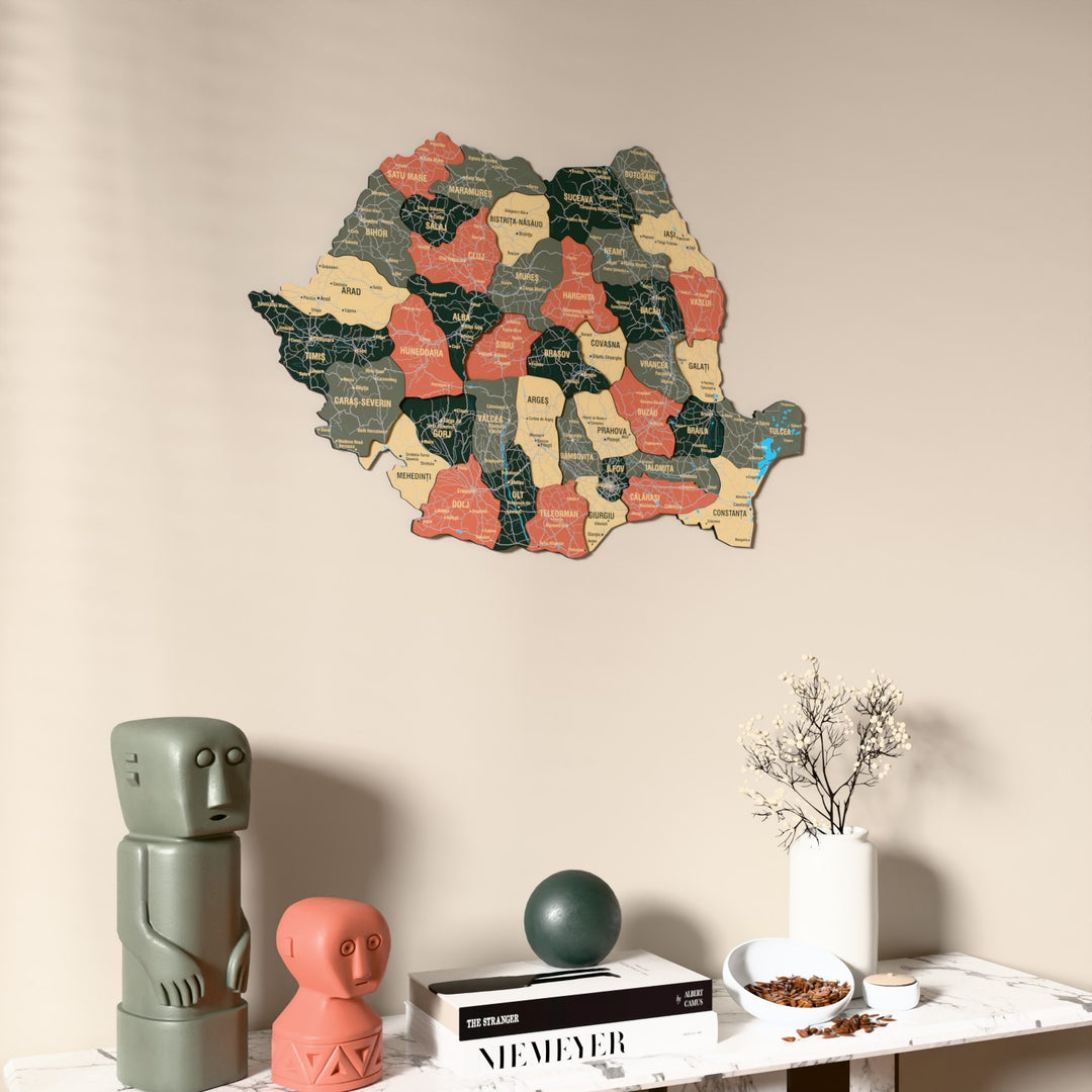 Sage Romania wooden wall map on a beige wall above a console with figurines