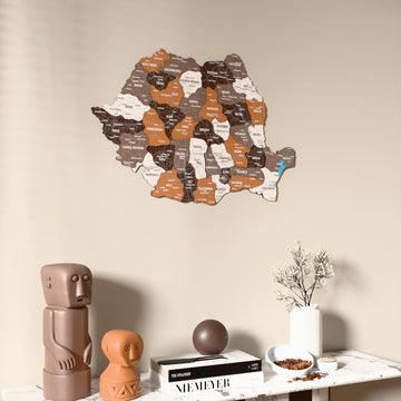 Soil Romania wooden wall map on a beige wall above a console with figurines