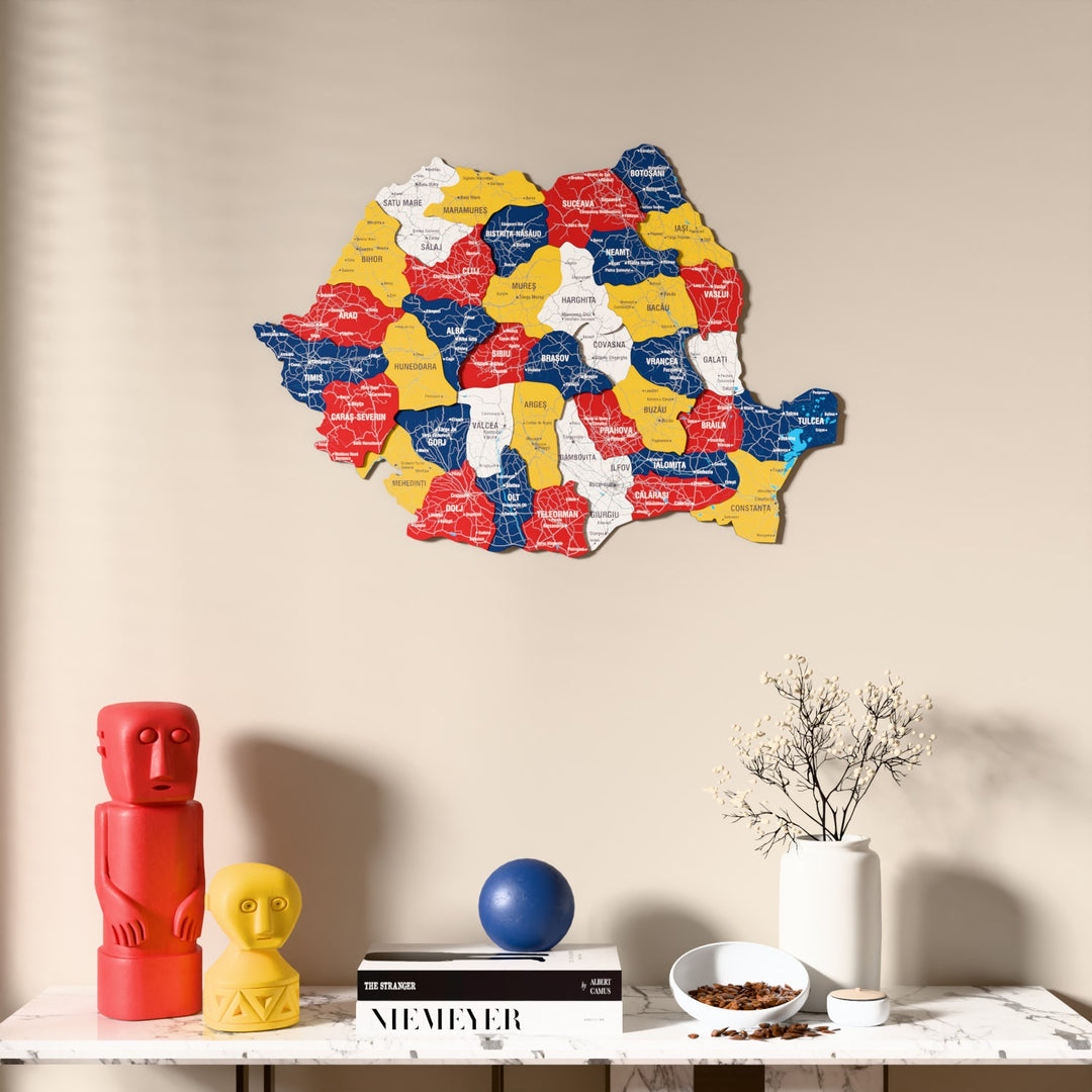 Flag colored Romania wooden wall map above a marble console, front view