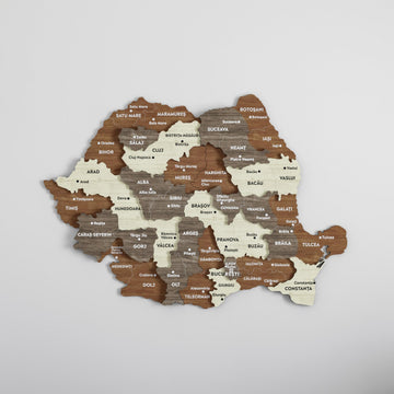 Romania wooden wall map with county and city names in brown, gray and cream layers, angled front view