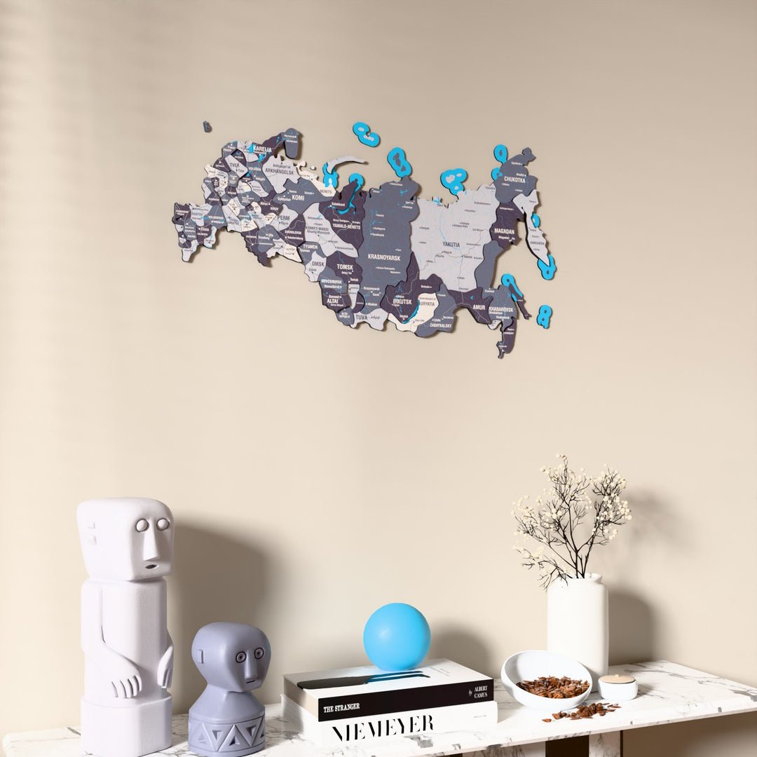 Nimbus Russia wooden wall map on a beige wall above a console with figurines