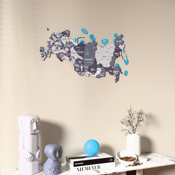 Nimbus Russia wooden wall map on a beige wall above a console with figurines