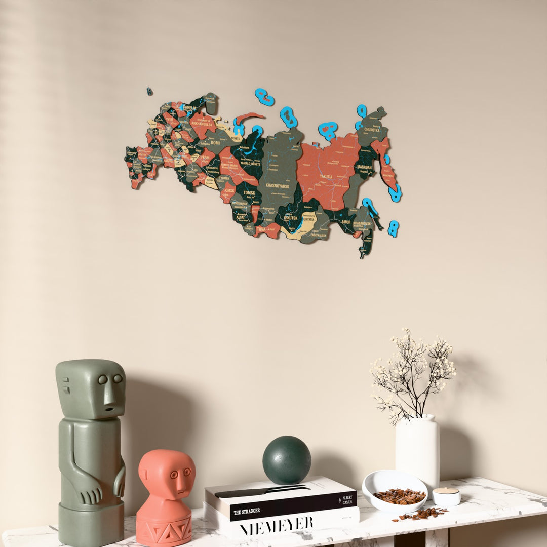 Sage Russia wooden wall map on a beige wall above a console with figurines