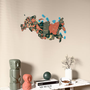 Sage Russia wooden wall map on a beige wall above a console with figurines