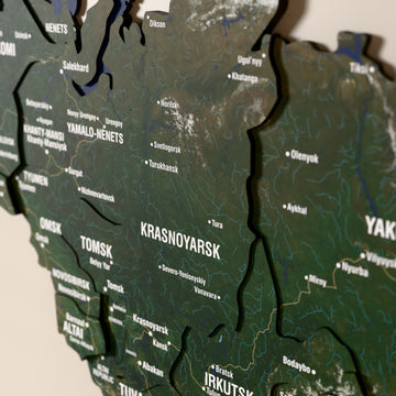 Close-up of the Satellite Russia wooden wall map with layered regions and printed names