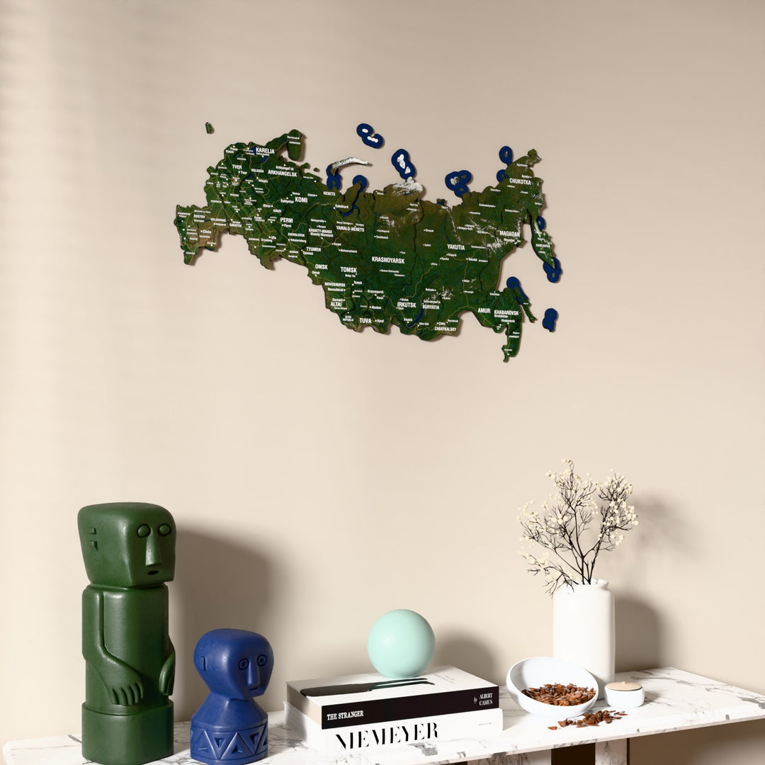 Satellite Russia wooden wall map on a beige wall above a console with figurines