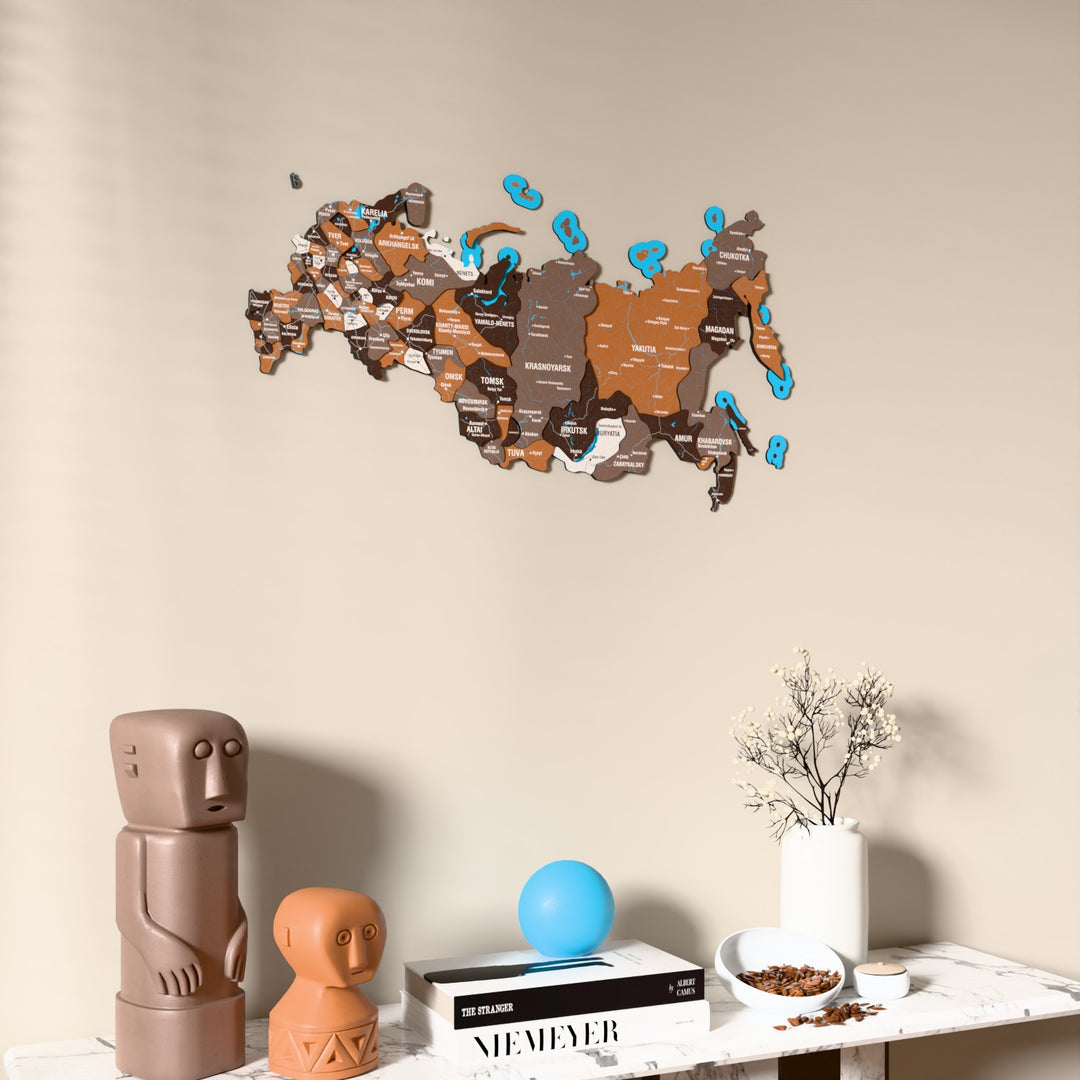 Soil Russia wooden wall map on a beige wall above a console with figurines