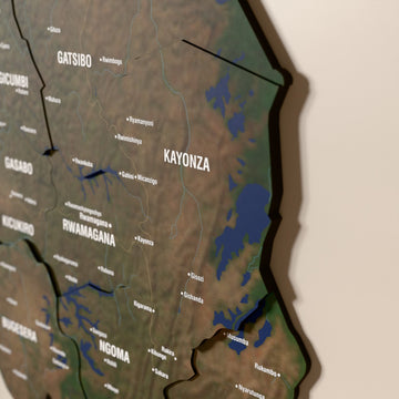 Close-up of the Satellite Rwanda wooden wall map with layered regions and printed names