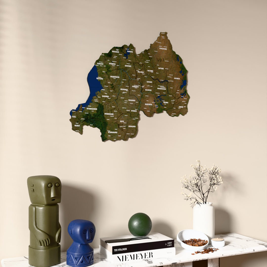 Satellite Rwanda wooden wall map on a beige wall above a console with figurines
