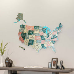 Sage UV printed metal USA wall map above a dark console with a vase and framed photos, wide view