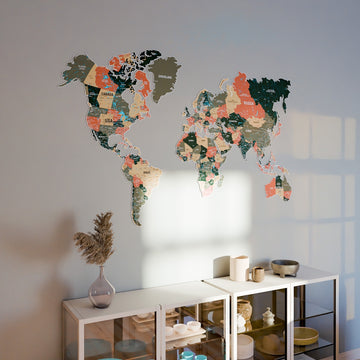 Sage metal world map above a white glass-door cabinet with a vase and pampas stem, wide view