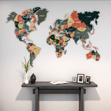 Sage metal world map above a dark console with framed photos and a plant, closer view