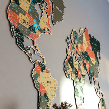 Angled close-up of the sage metal world map showing North and South America with country names